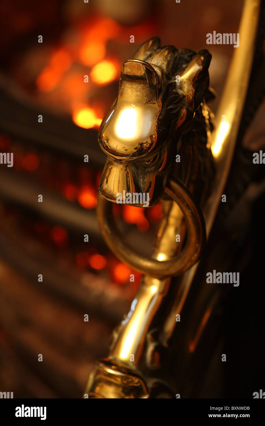 brass fire surround with glowing embers in background Stock Photo Alamy