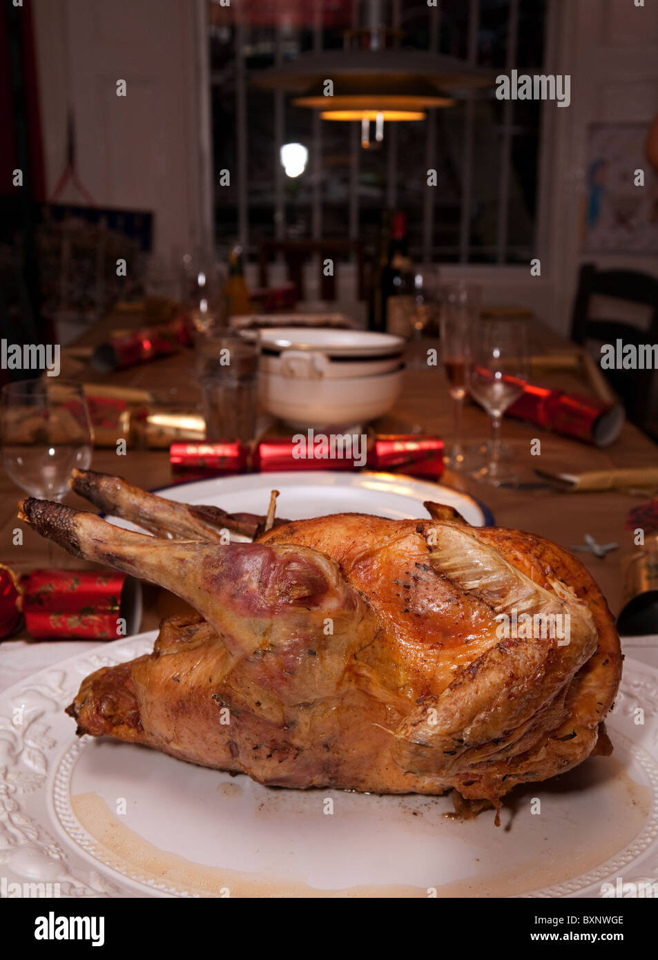 Roast Turkey ready for carving at the head of the table set for
