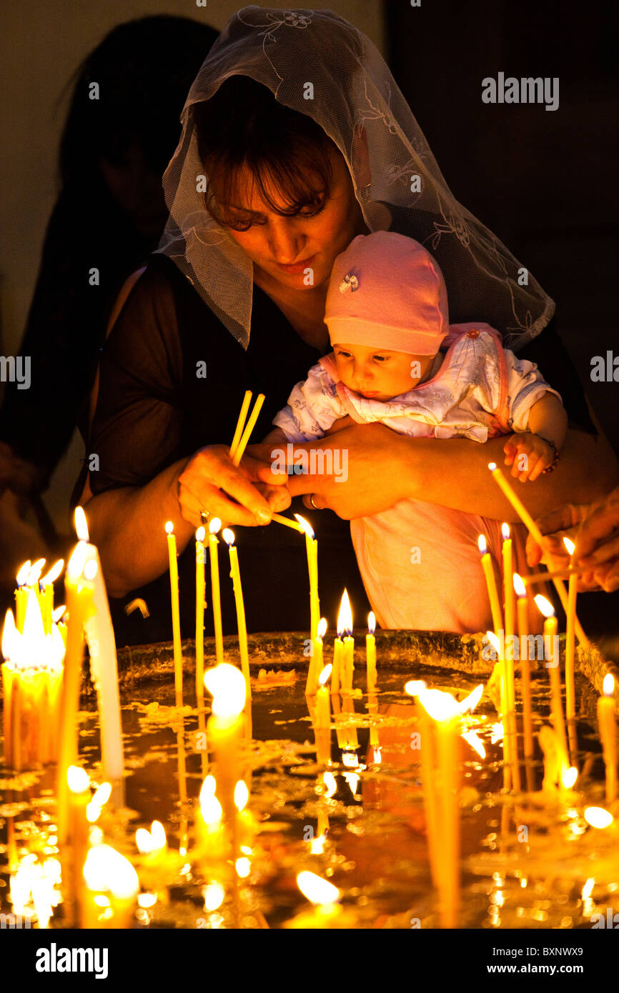 Lighting candles, Cathedral of Mayr Tacher at Echmiadzin near Yerevan Armenia Stock Photo
