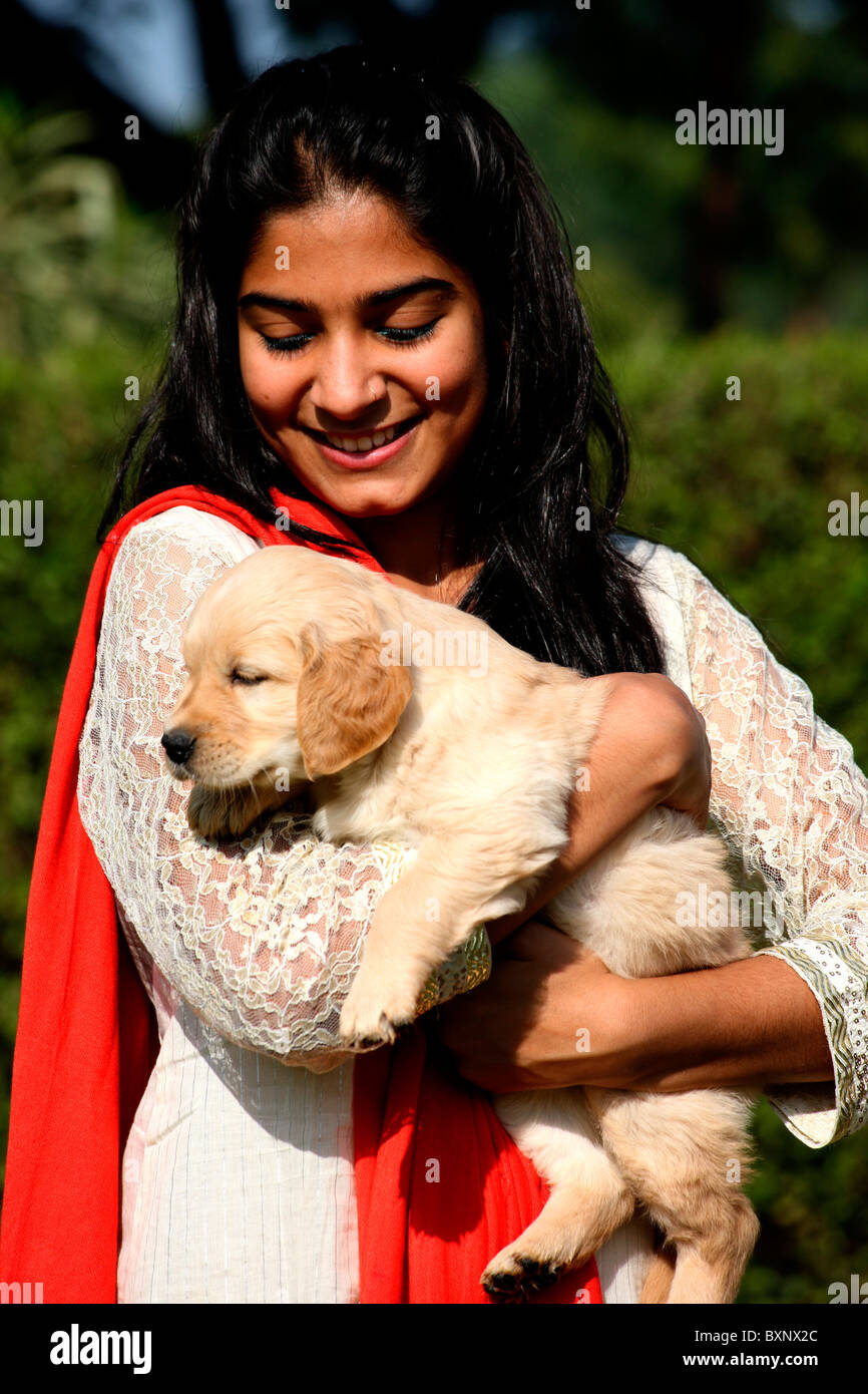 Smiling Indian girl with a puppy Stock Photo - Alamy