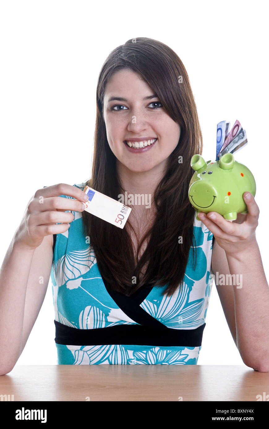 Young woman with her piggy bank Stock Photo