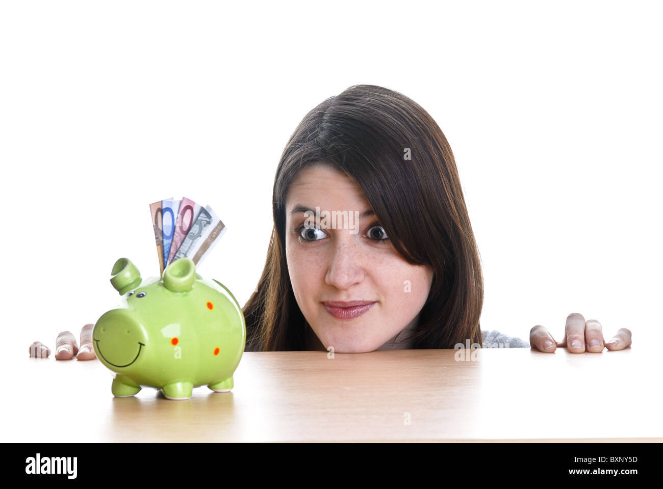 Young woman with her piggy bank Stock Photo