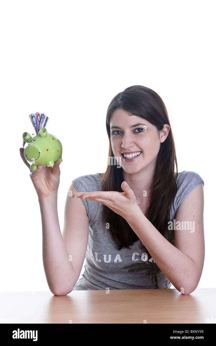 Young woman with her piggy bank Stock Photo