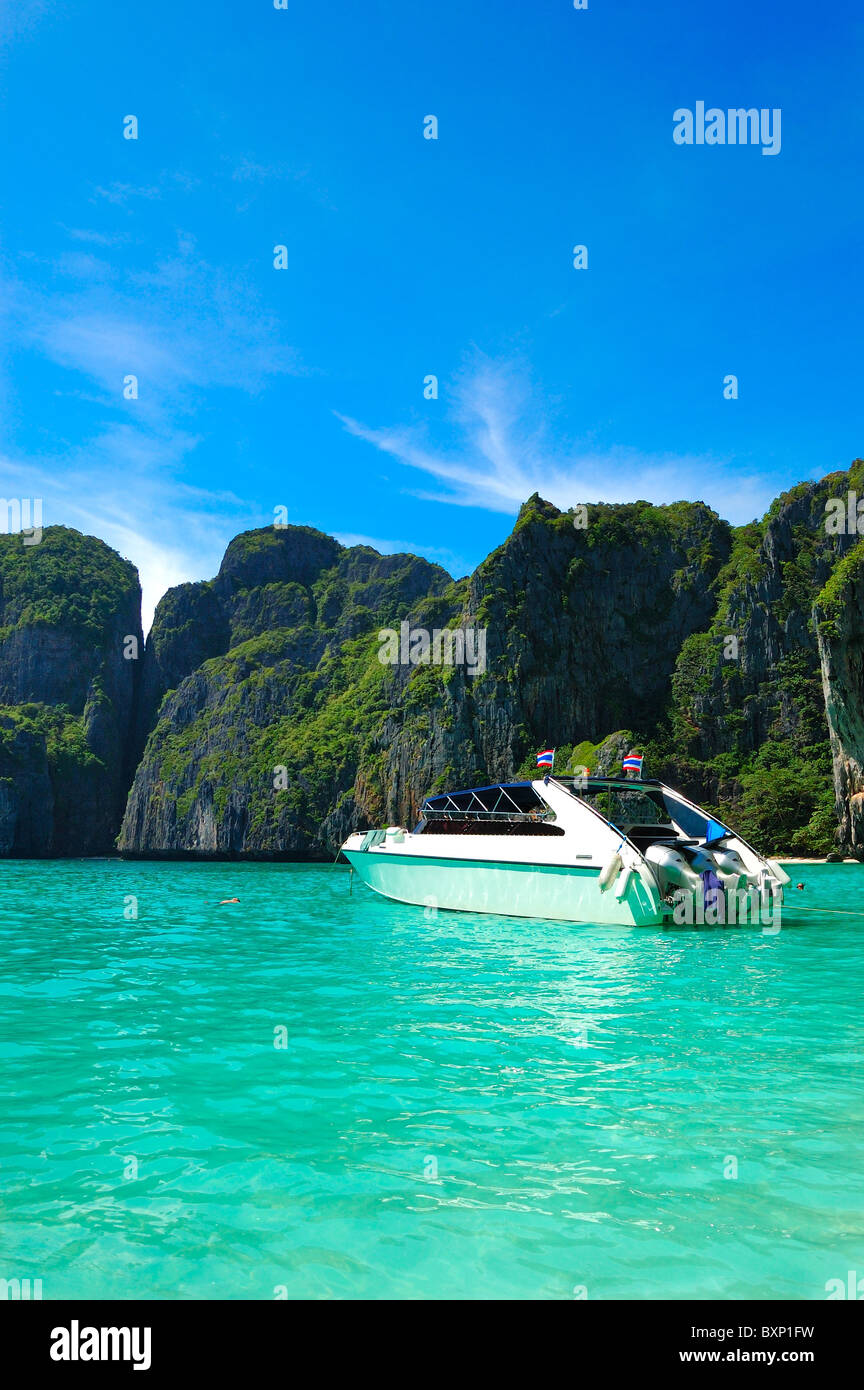 Motor boat on turquoise water of Maya Bay lagoon, Phi Phi island, Thailand Stock Photo