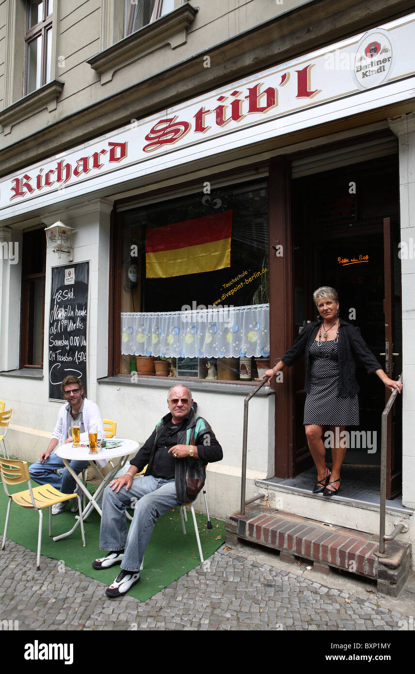 Waitress and guests in front of a pub in Berlin, Germany Stock Photo