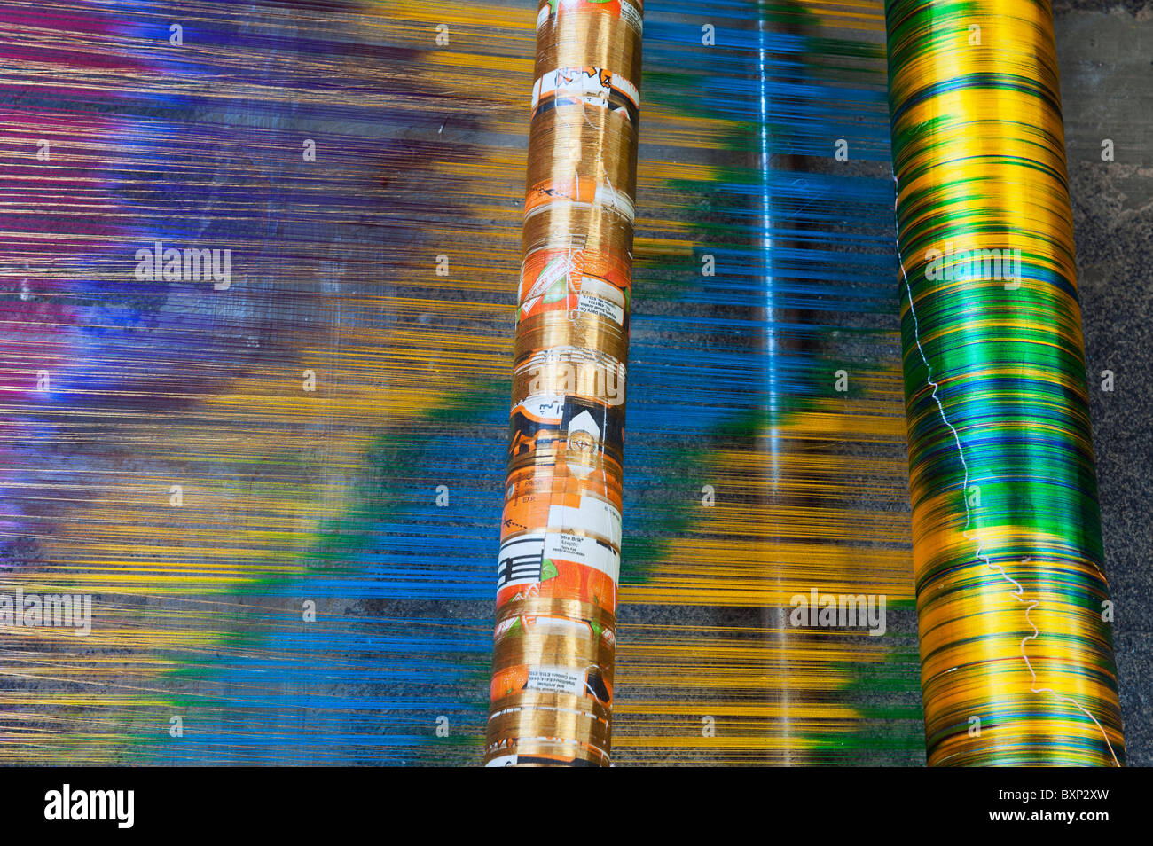 Silk thread on a Hand loom making a silk sari in an Indian cottage. Andhra Pradesh, India Stock Photo