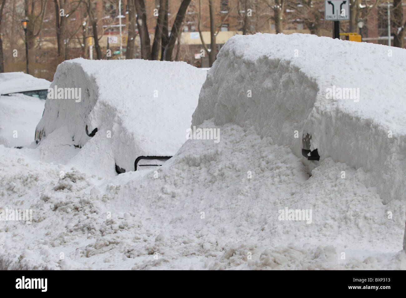 Cars buried by drifting snow on Manhattan's Upper West Side a day after
