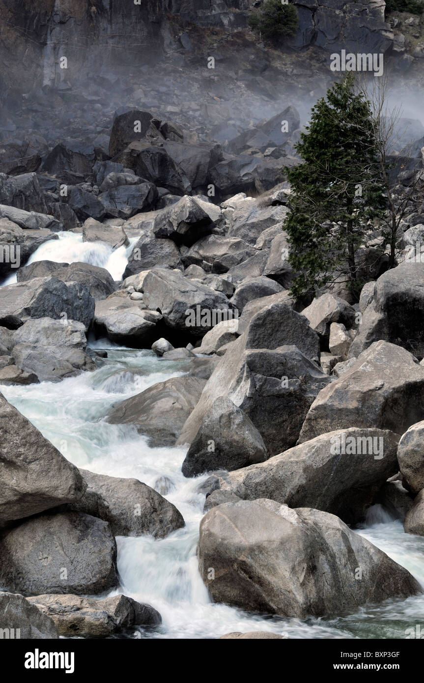 River rushing flowing downstream of Lower yosemite falls waterfall section bottom national park valley california USA Stock Photo