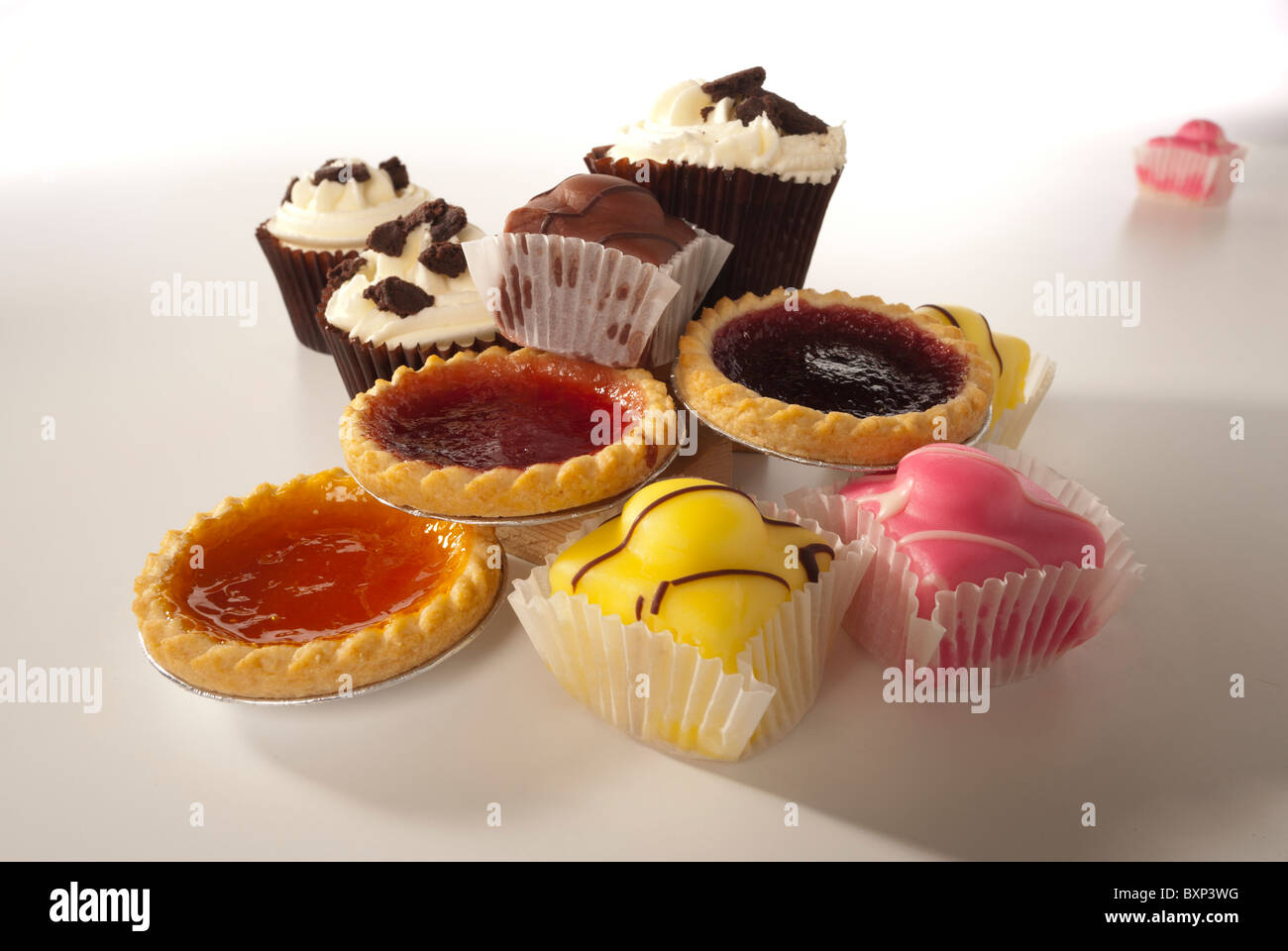 Tea cakes, fondant fancies, jam tarts and fairy cakes Stock Photo
