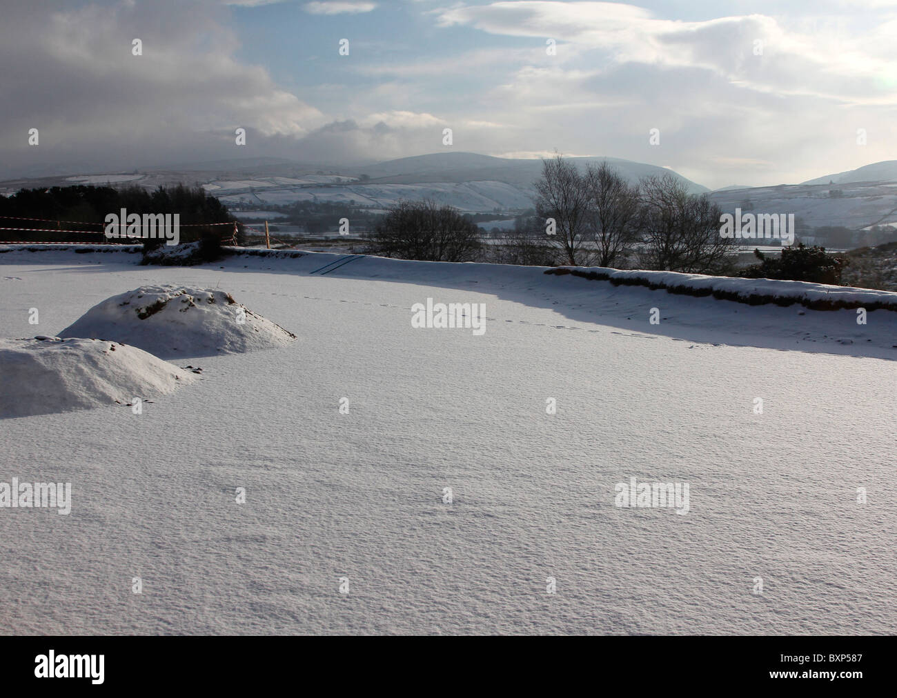 Frozen, snow-covered pond in Cumbria. Stock Photo