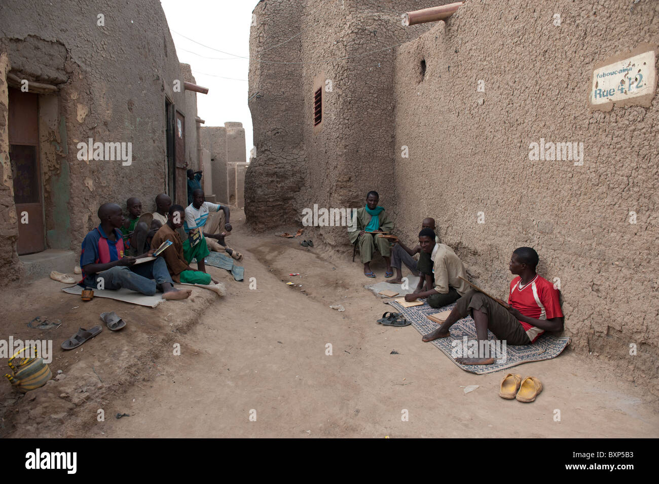 Young students in an outdoor Koran school . Djenné, Mali Stock Photo