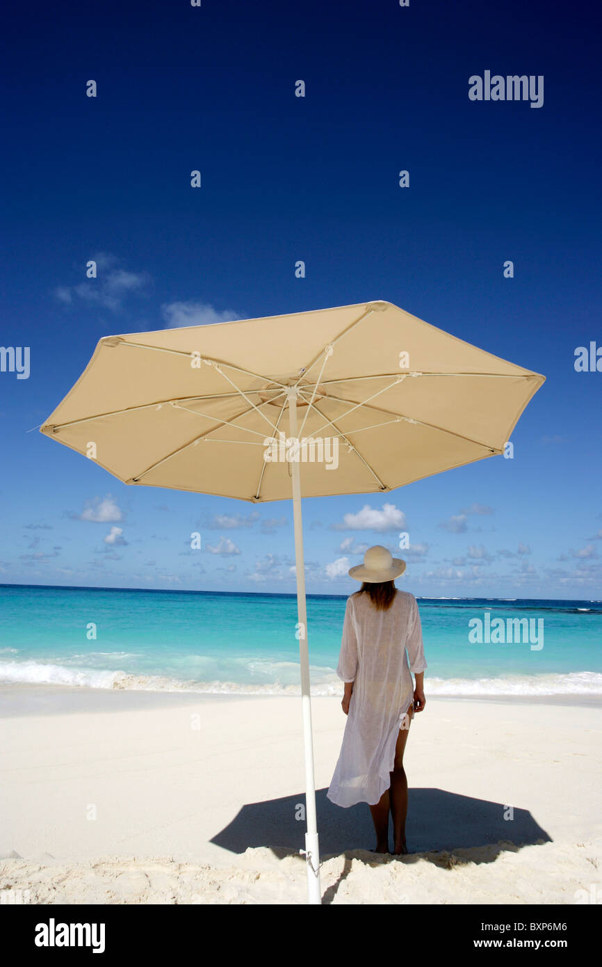 Woman Under Umbrella On Beach Stock Photo