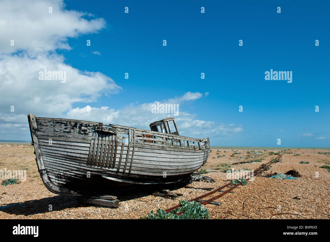 Abandoned old wooden boat on Dungerness shingle and pebble beach Stock Photo