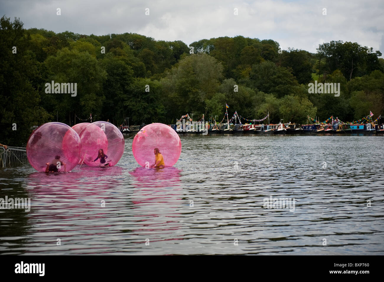 Four children water zorbing on the river thames Stock Photo