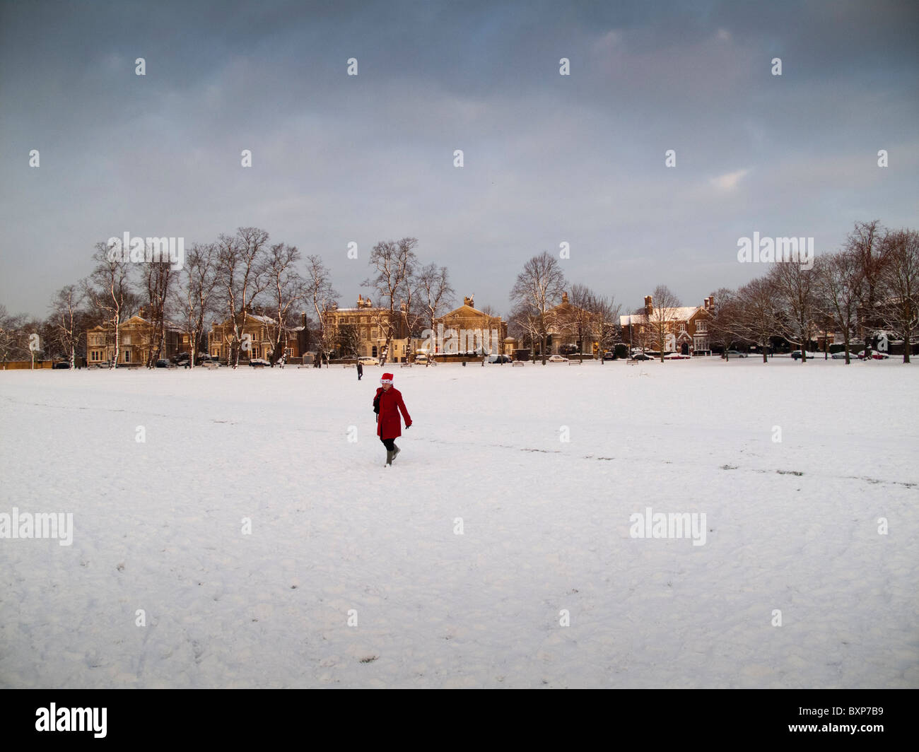 Woman wearing a festive Santa's hat, walking to work,The Green,Richmond Upon Thames,Surrey,England Stock Photo