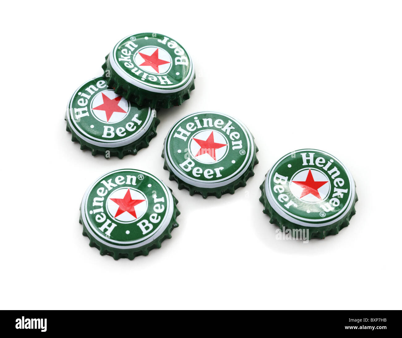 Heineken beer bottle caps on white background. Stock Photo