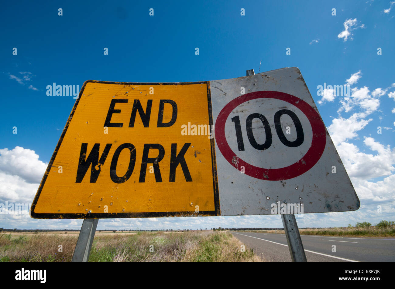 Signs indicating end of road work and speed limit of 100 kph Stock Photo