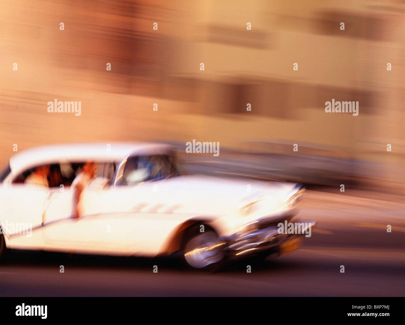 People Driving A Classic American Car In Havana, Blurred Motion Stock Photo