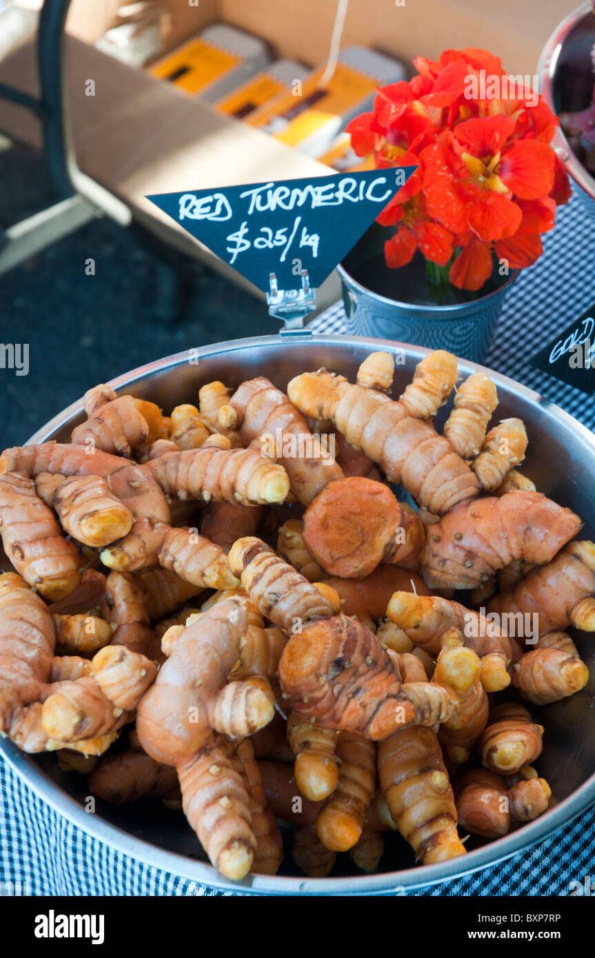 Red turmeric tubers for sale in a farmer's market Stock Photo