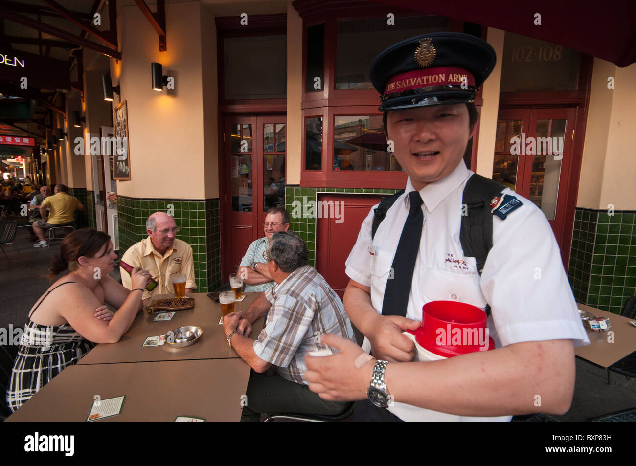 A Chinese Salvation Army member collecting money in the pubs of Chinatown in Sydney Australia Stock Photo