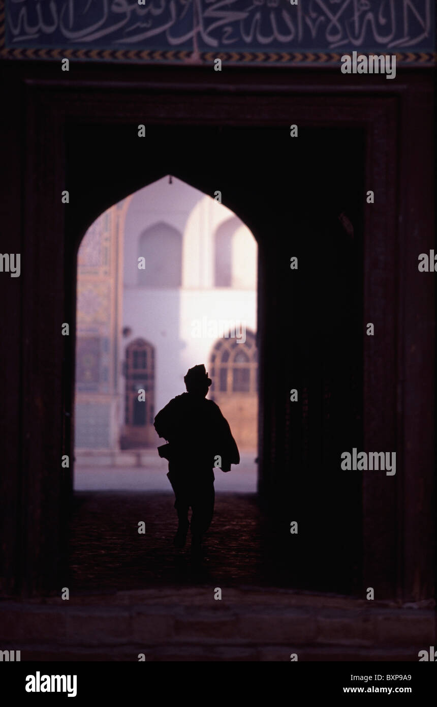 Boy Silouhetted Against The Opening Of Mosque Stock Photo