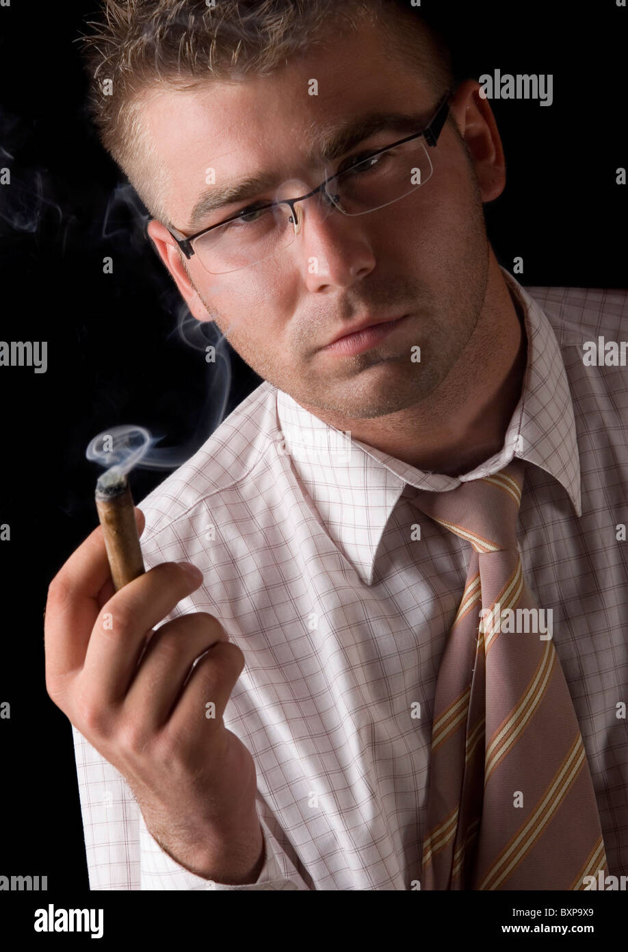 Businessman smoking cigar Stock Photo Alamy