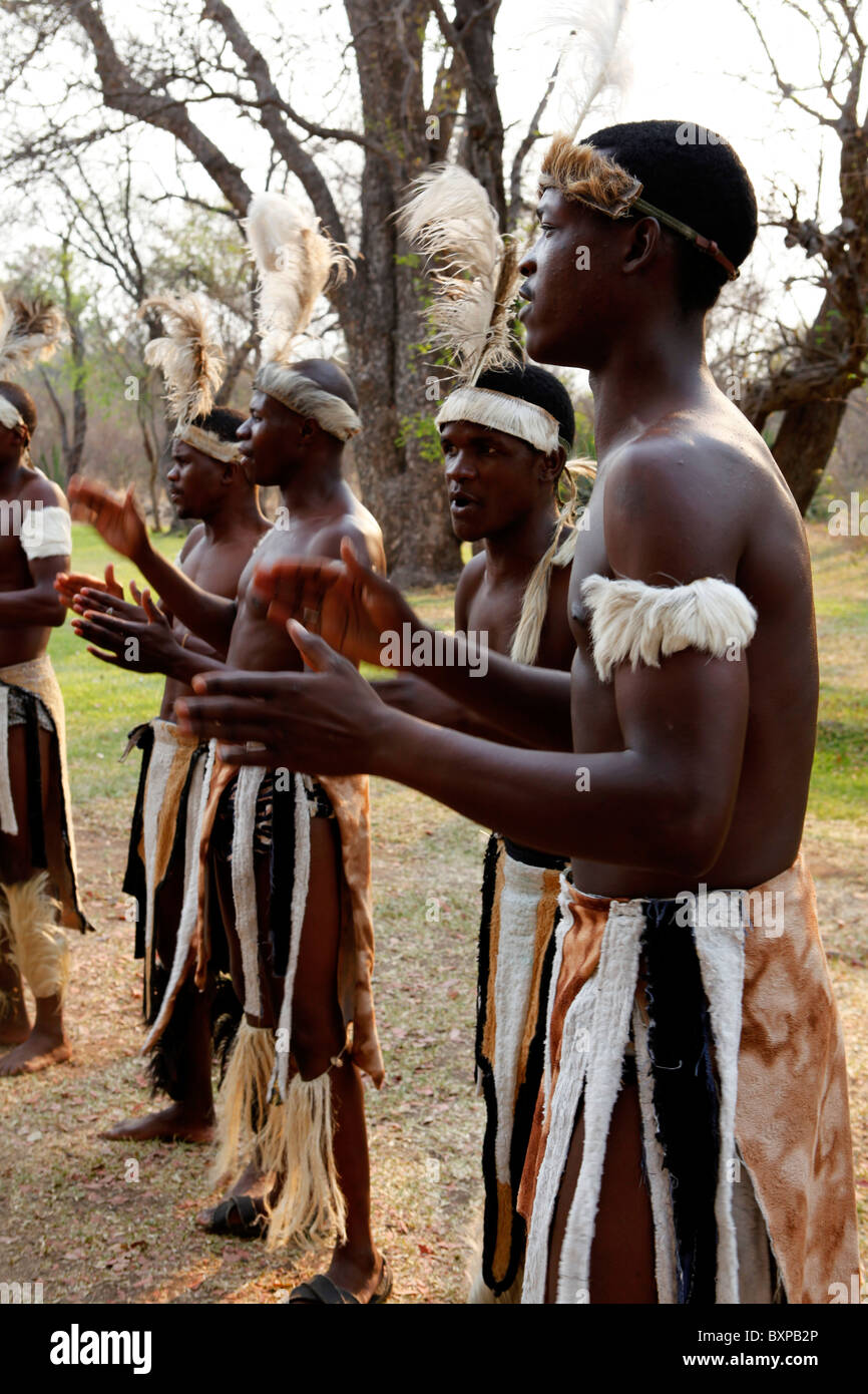 Traditional tribal singers dance at Victoria Falls in Zimbabwe. Stock Photo