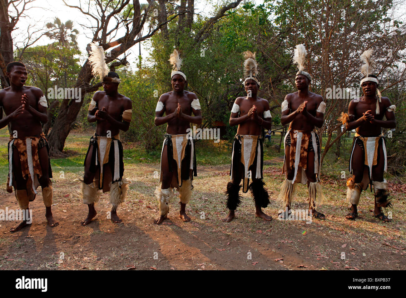 Traditional tribal singers dance at Victoria Falls in Zimbabwe Stock
