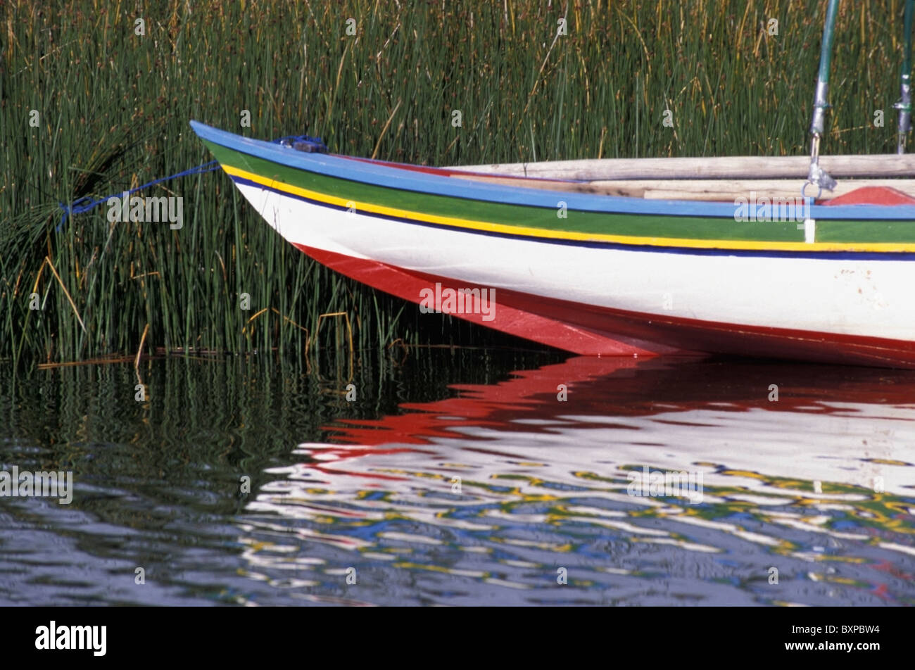Brightly Painted Boat Among Reeds In Lake Titicaca Stock Photo