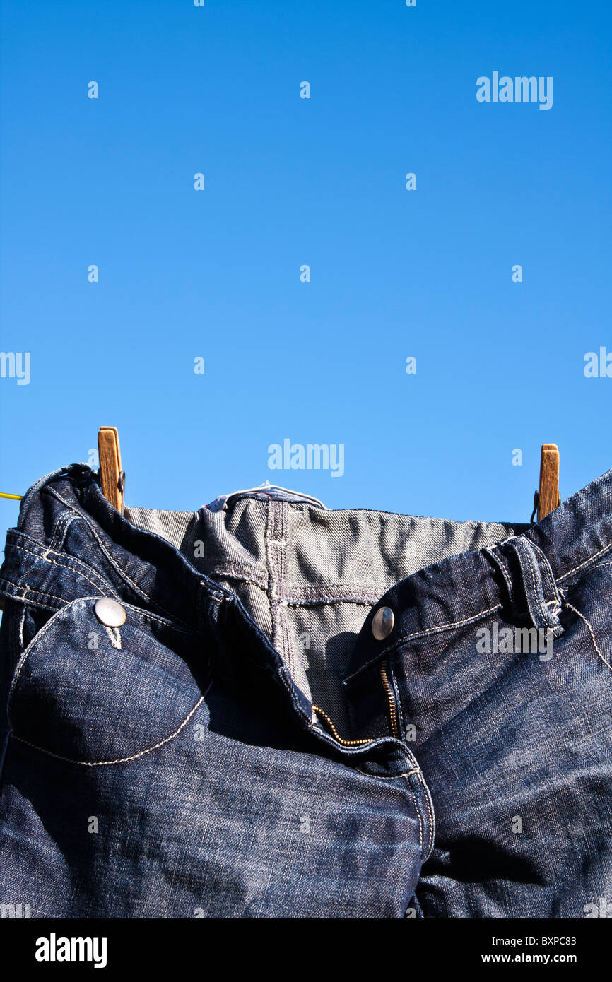 Blue denim jeans drying on clothes line Stock Photo Alamy