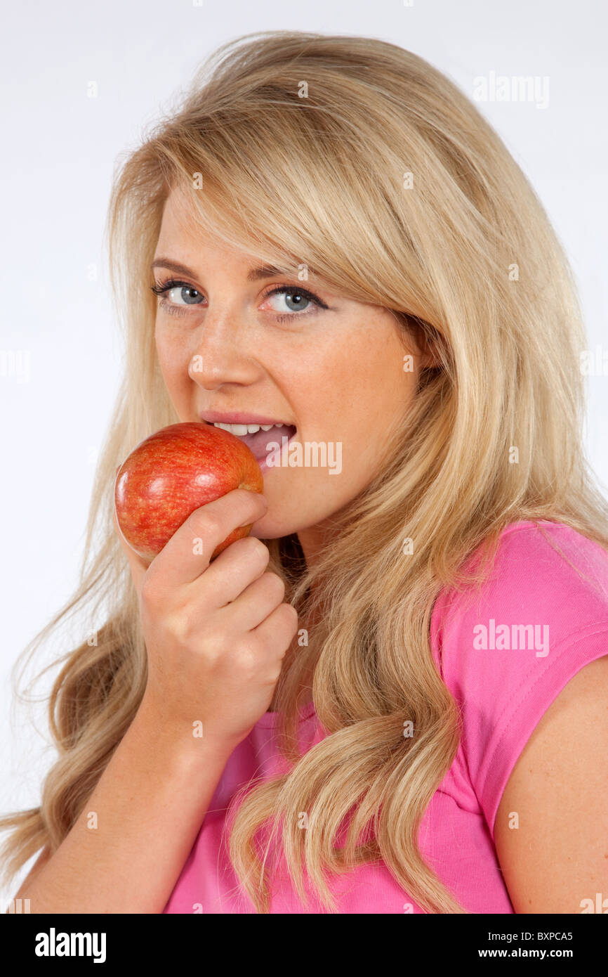 Young caucasian blond Woman holding apple showing a healthy lifestyle Stock Photo