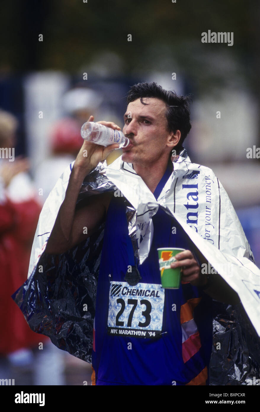 Runner drinking and wearing a space blanket after competing in the 1994
