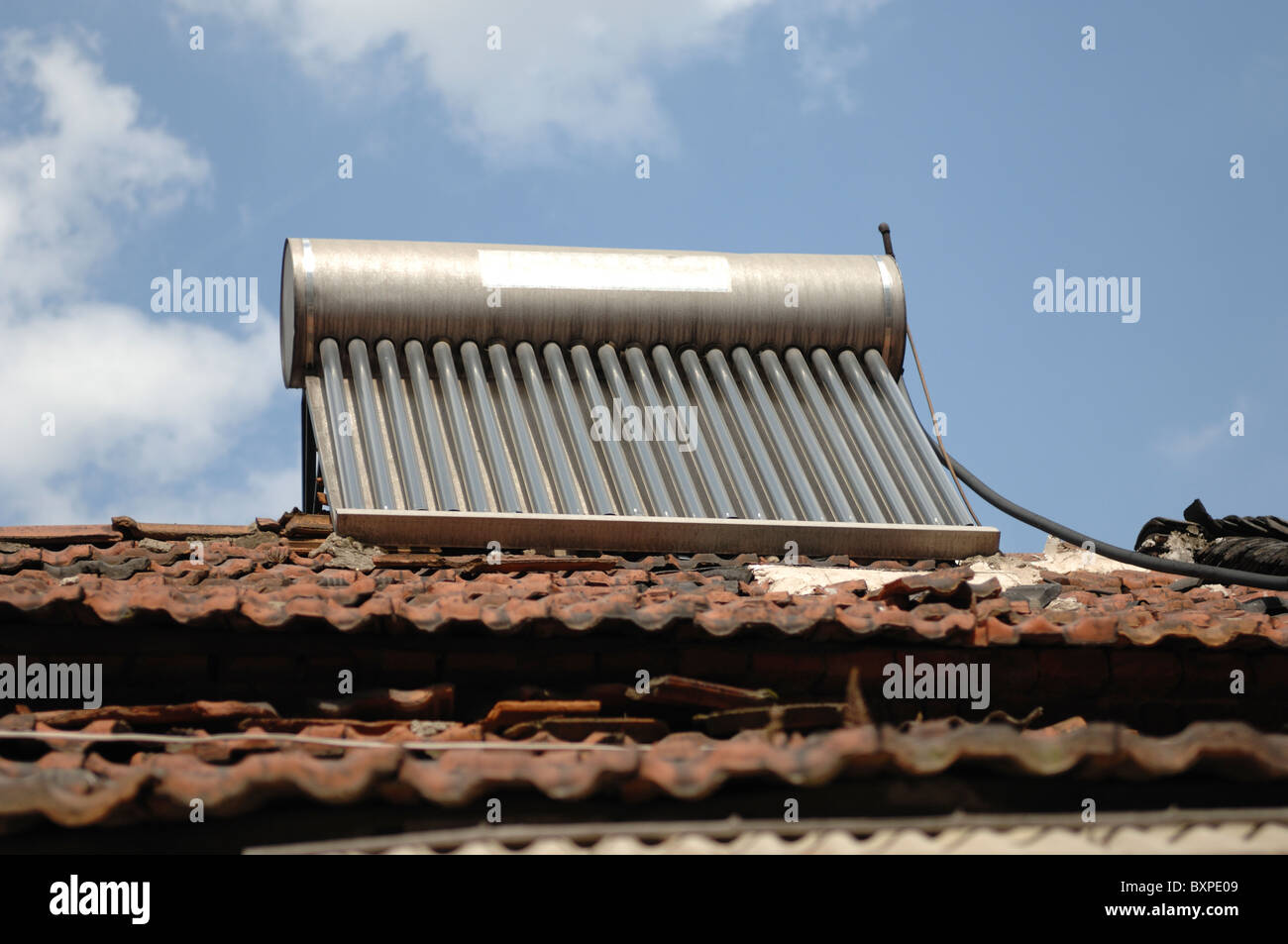 A n environmentally friendly solar water heater on the tiled roof of a house in Yangzhou Jiangsu Province of China Stock Photo