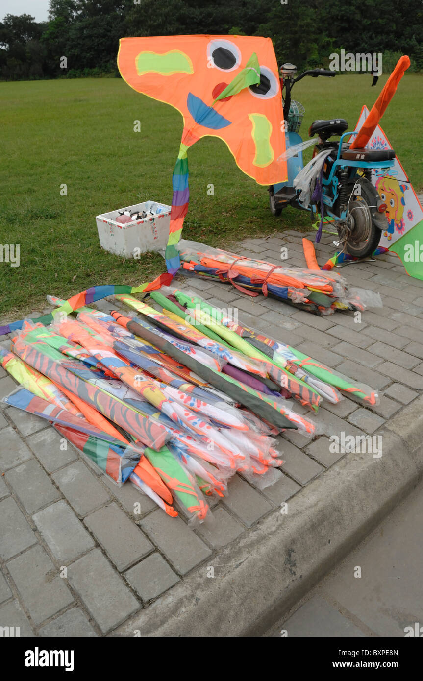 Kites for sale on the sidewalk pavement in Yangzhou Jiangsu Province of China Stock Photo