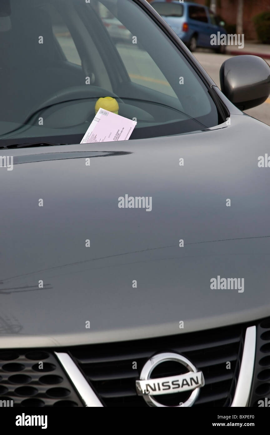 A car with a parking ticket issued due to an expired meter. Stock Photo