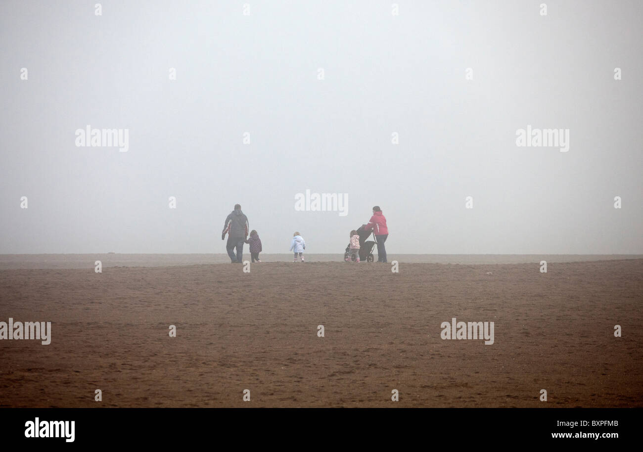 Skegness, Lincolnshire, UK.Skegness, Lincolnshire, UK. A family brave the fog on the beach in Skegness. Stock Photo