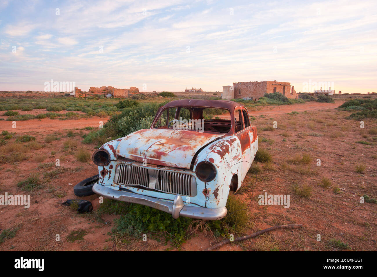 Rusty car wreck the abandoned town of Farina in outback South Australia at twilight Stock Photo