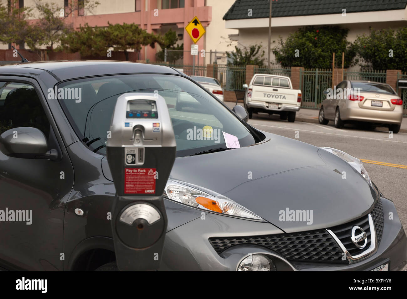 A car with a parking ticket issued due to an expired meter. Stock Photo