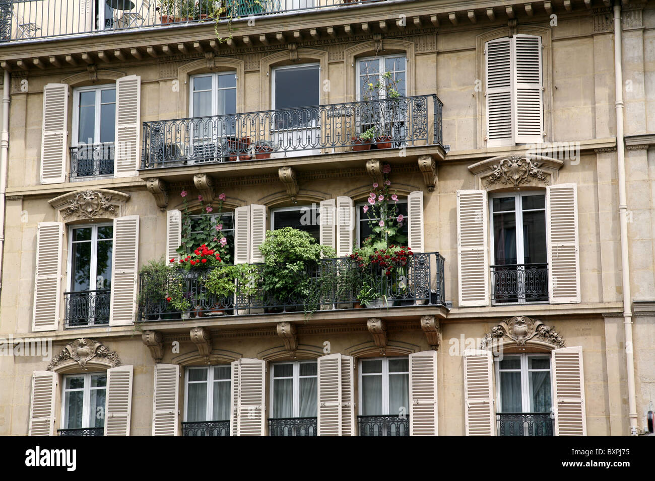 Paris apartment building balcony with flowers Stock Photo