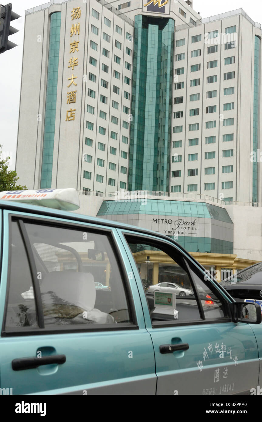 A green taxi and hotel in Yangzhou Jiangsu Province of China Stock Photo