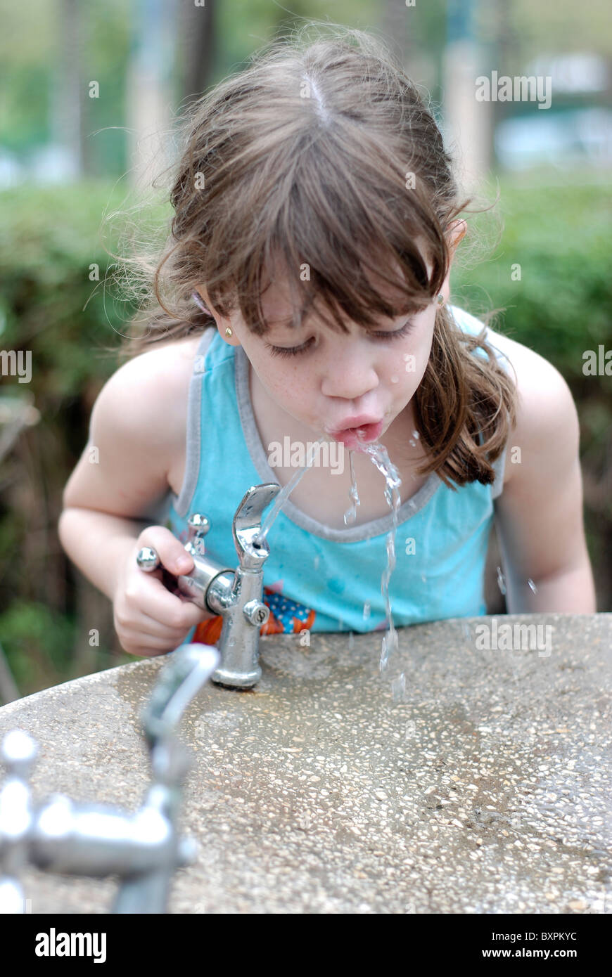 Young girl of 4 drinks water from a water fountain Stock Photo Alamy