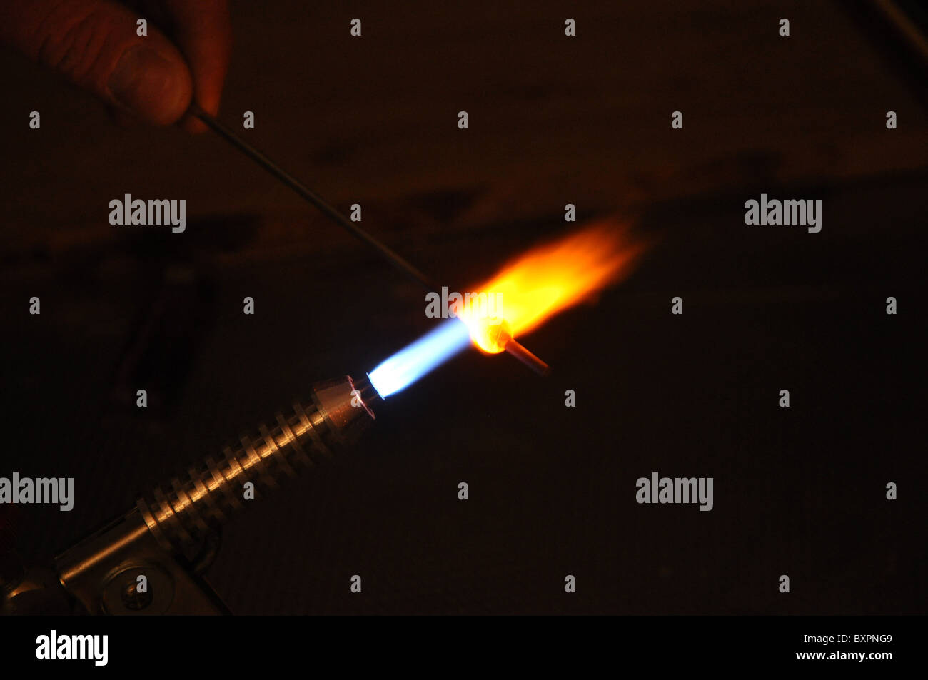 Soldering torch with blue and yellow coloured flame Stock Photo Alamy