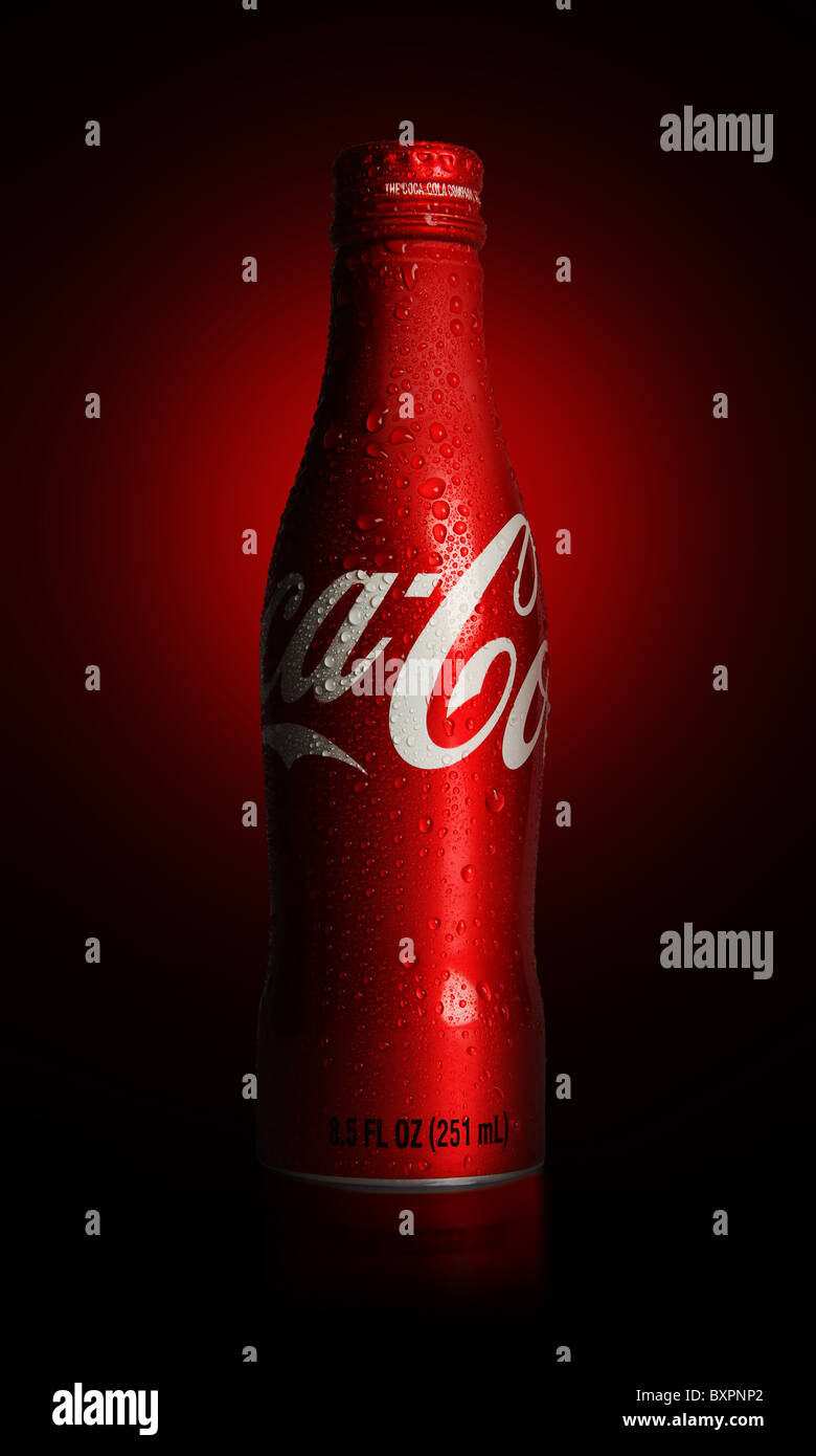 An 8.5 fluid ounce of Coca-Cola aluminum bottle with droplets shot on red and black radial background Stock Photo