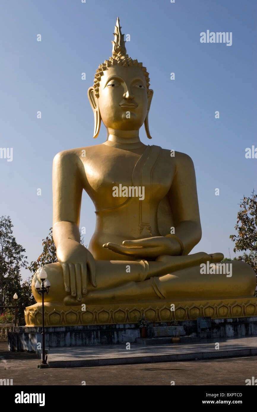 A large gold Buddha statue is on display at a beautiful Buddhist temple