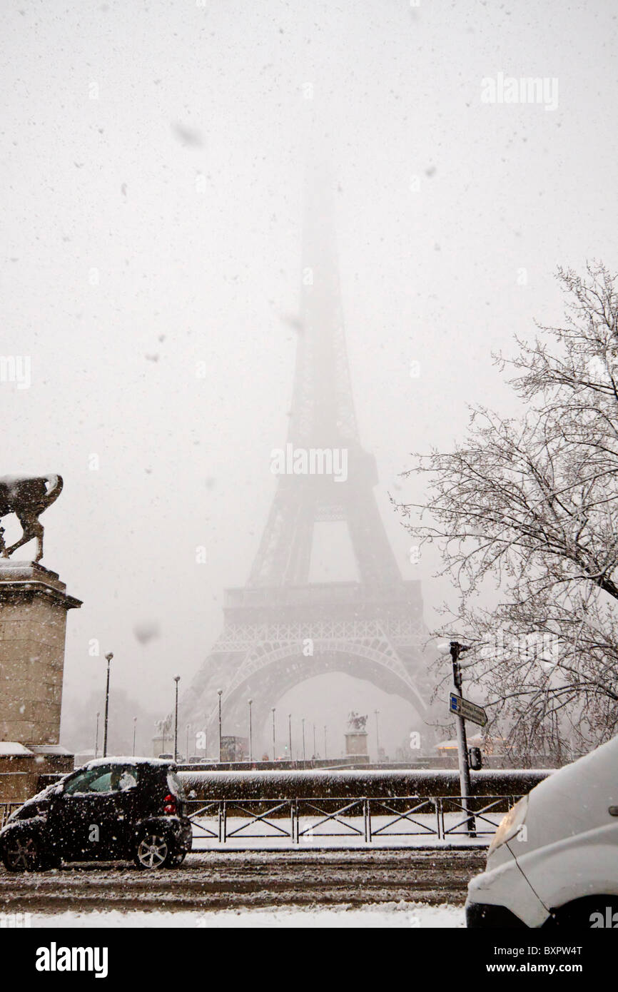 The Eiffel Tower is nearly obscured by falling snow during an early winter storm in Paris, France Stock Photo