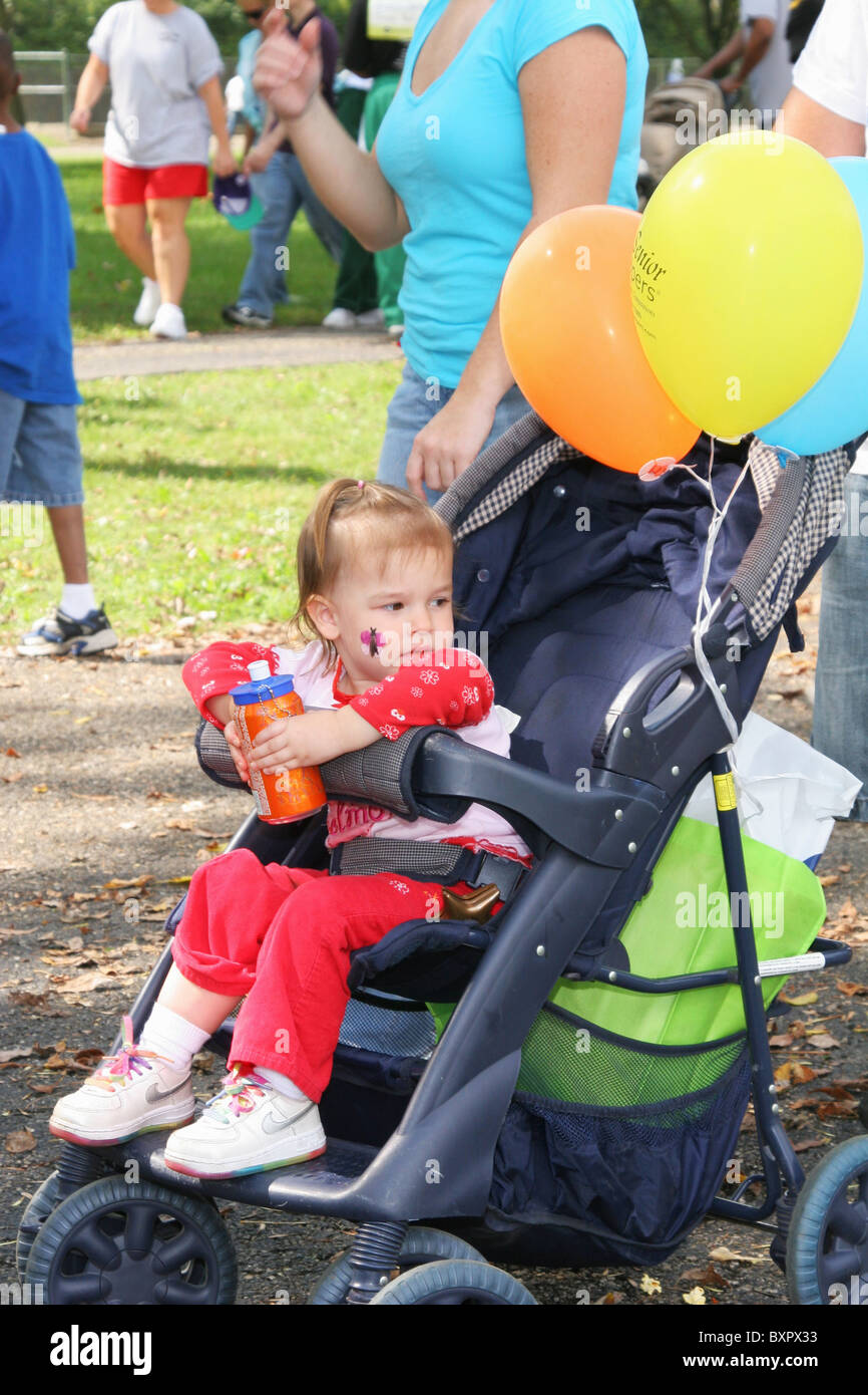 Toddler in Stroller with soft drink can. Alzheimer's Memory Walk. Walk