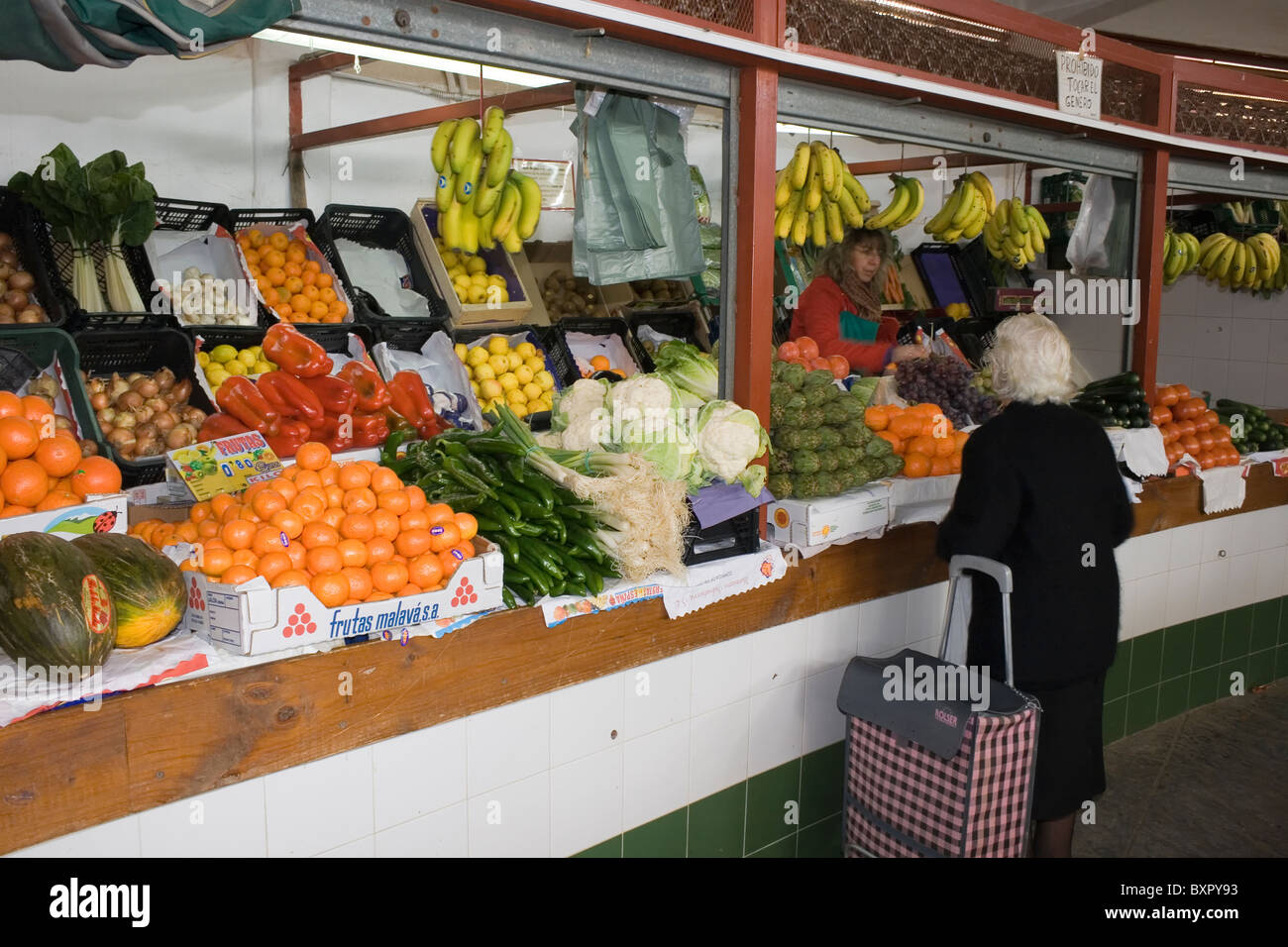 Woman buying fruit off fruit and vegetable stall in the central market, Andujar, Jaen, Spain. Stock Photo