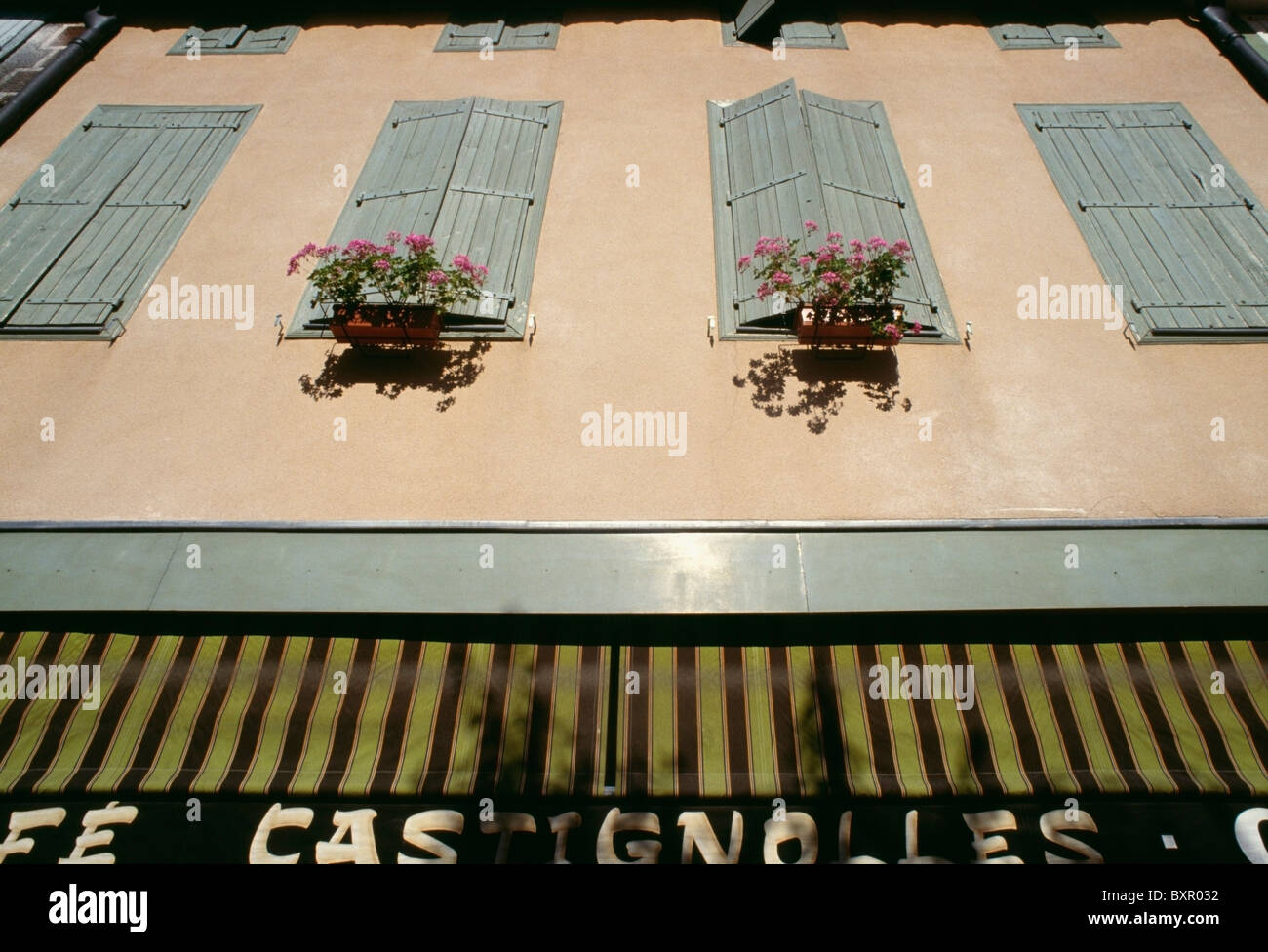 Building With Shutters, Flower Boxes And Awning, Close-Up Stock Photo