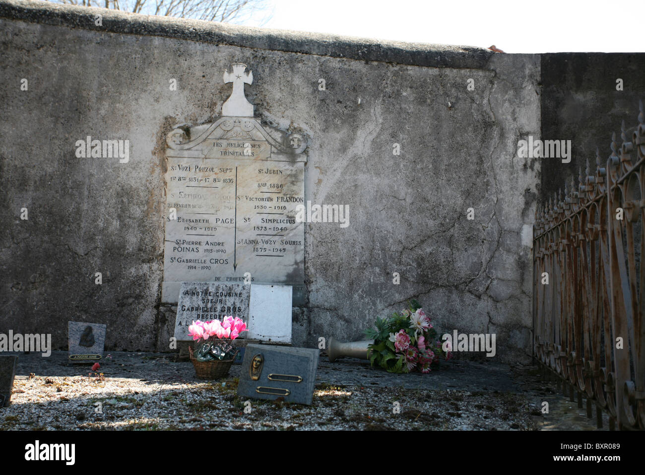 A family burial site, with ornaments and potted flowers, in a French cemetery. Stock Photo