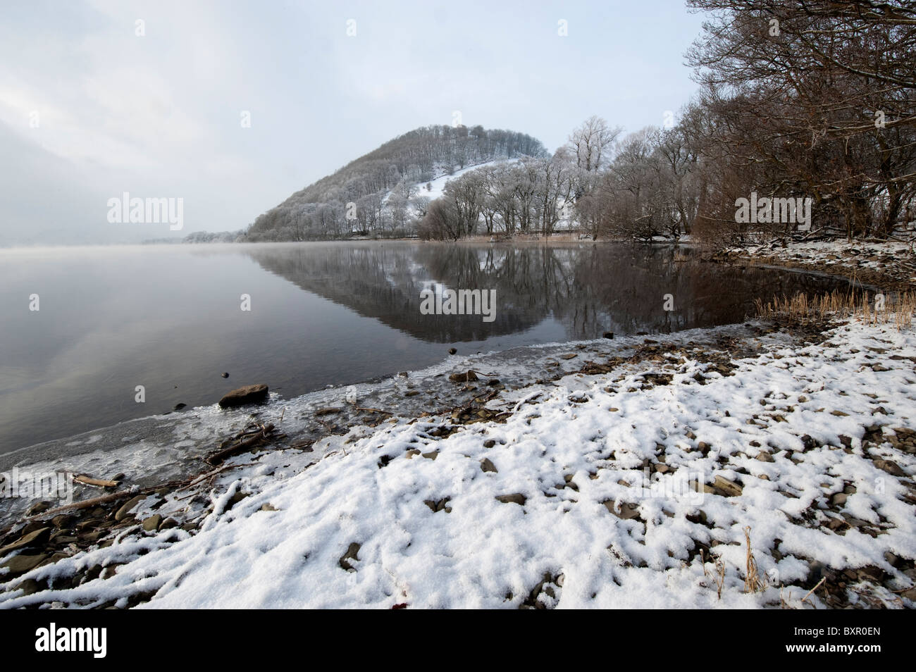 Early morning mist on Ullswater in the English Lake District on a cold winter morning. Stock Photo